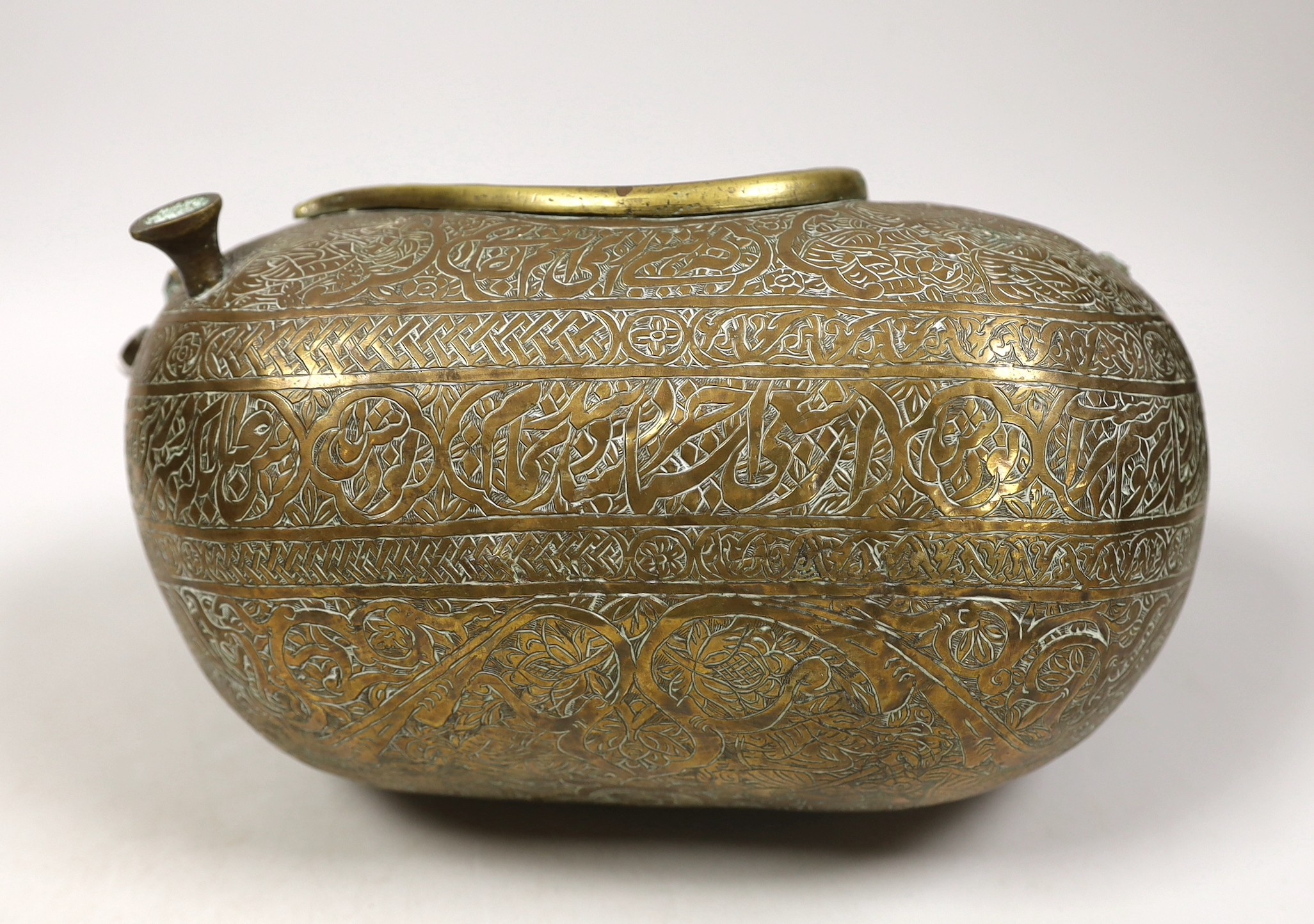 A 19th century Persian engraved brass kashkul, Qajar dynasty, 16cm wide and a bronze kettle, 17cm tall